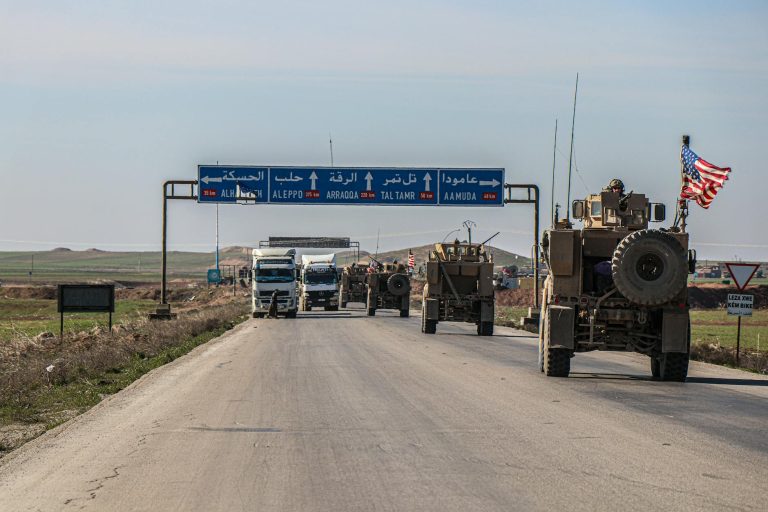 moving vehicles on the road under blue sky